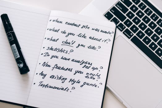 Close-up of a notebook with handwritten notes next to a laptop, ideal for business or educational content.