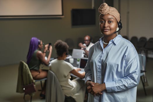 Muslim woman with headset leading a diverse team meeting in a modern office setting.